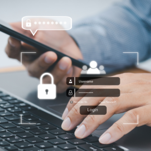 Persoon logt op laptop in met behulp van mobiel